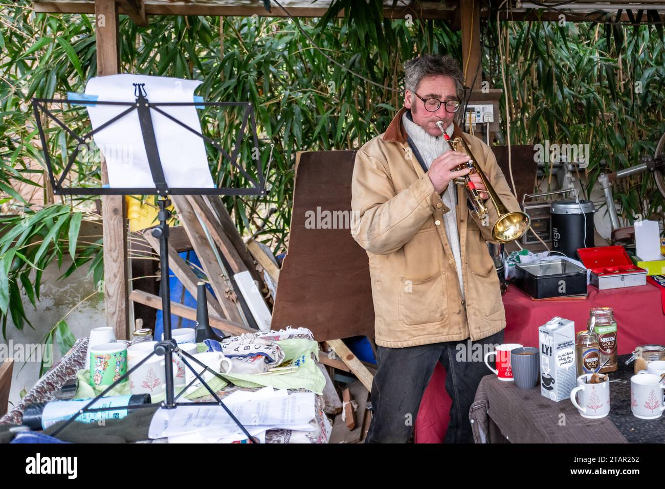 Twickenham, UK. Sat 2 Dec 2023. Eel Pie Island, on the River Thames in London, opens to the public twice each year. Local artist plays a trumpet. Credit: Thomas Faull/Alamy Live News Stock Photo