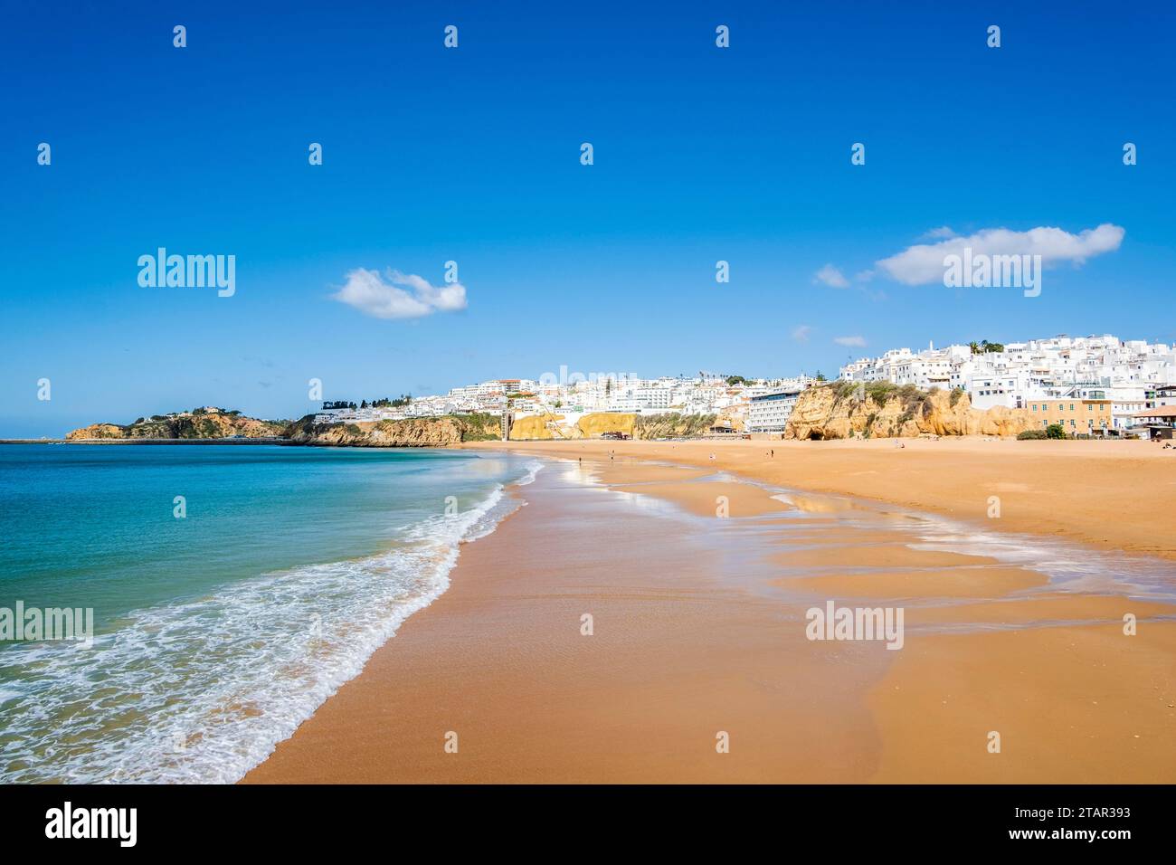 Great view of Fisherman Beach, Praia dos Pescadores, with whitewashed houses on cliff, reflecting on the sea, blue sky, summer time, Albufeira Stock Photo