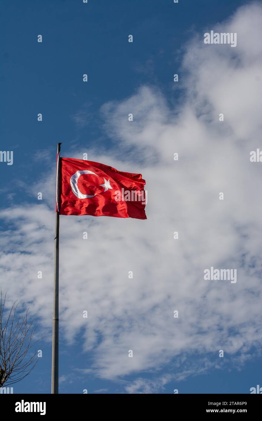 Turkish national flag with white star and moon on a pole in sky Stock