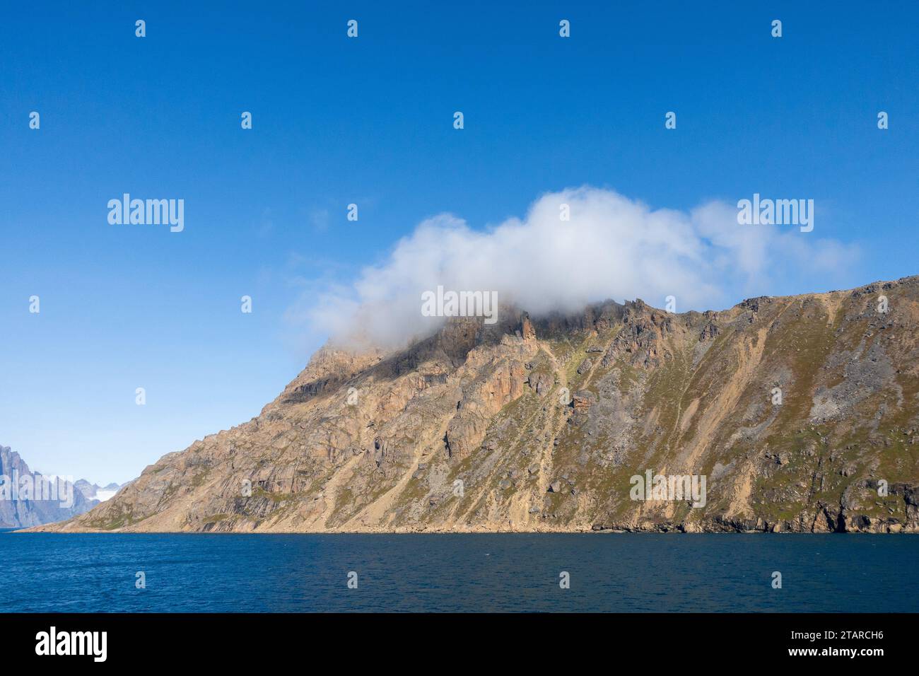 Low Cloud On A Mountain In Prince Christian Sound Fjord Greenland, In Southern Greenland Seascape, Ocean, Cliff Mountainside, Isolated Cloud Stock Photo