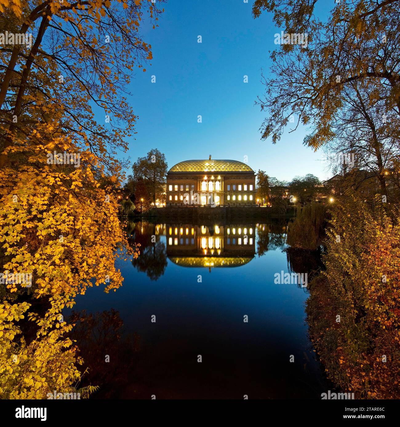 The Staendehaus K21 is reflected in the Kaiserteich in autumn in the evening, Schwanenspiegel, Duesseldorf, North Rhine-Westphalia, Germany Stock Photo