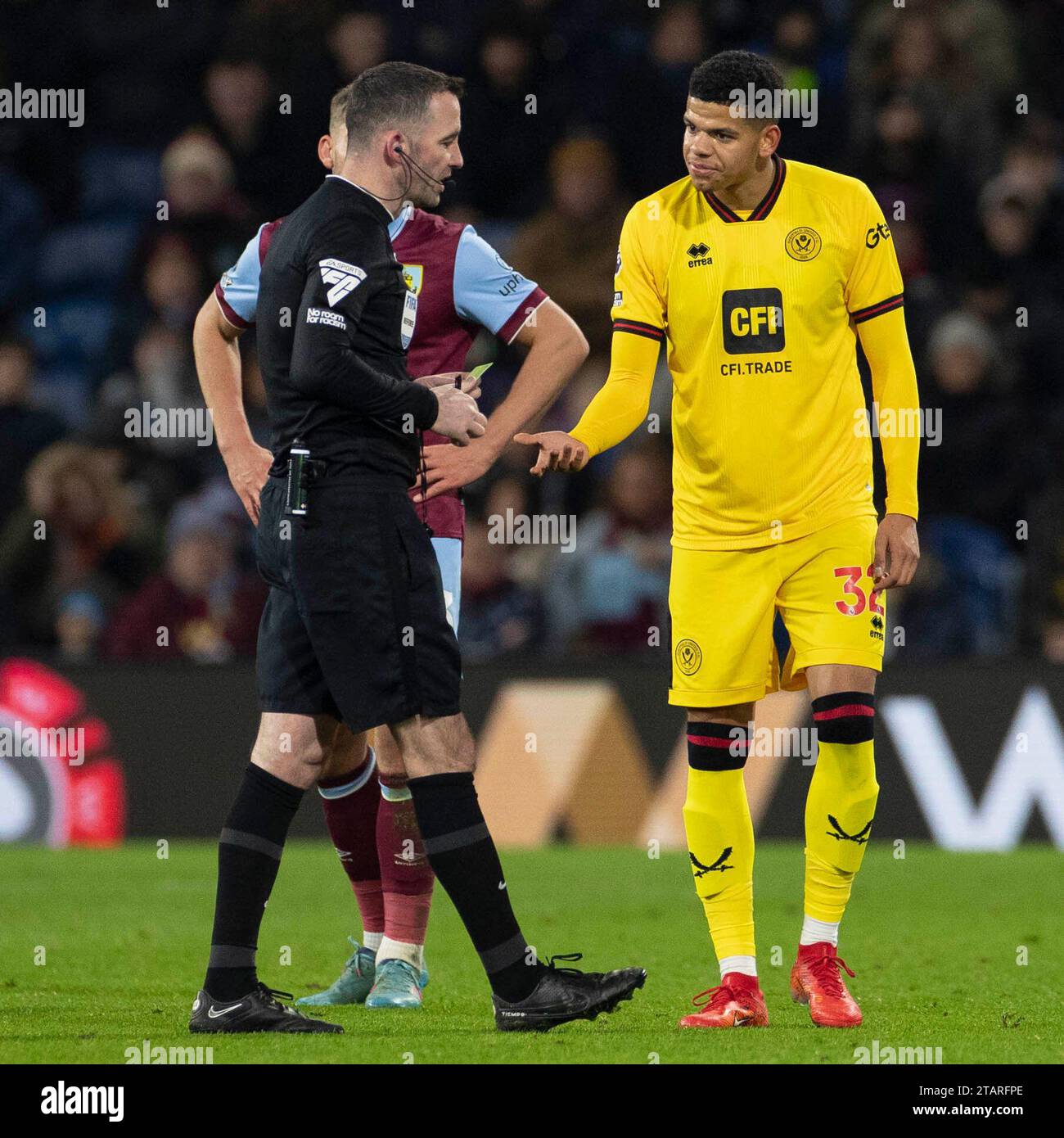 Referee Christopher Kavanagh shows a yellow card to William Osula #32 of Sheffield United during the Premier League match between Burnley and Sheffield United at Turf Moor, Burnley on Saturday 2nd December 2023. (Photo: Mike Morese | MI News) Credit: MI News & Sport /Alamy Live News Stock Photo