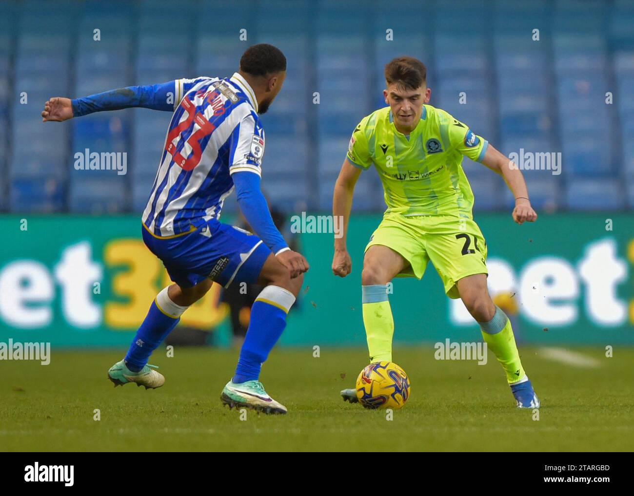 Akin Famewo 23 of Sheffield Wednesday tackles Harry Leonard 20 of