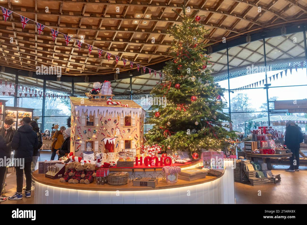 People Christmas shopping in Savill Garden visitor centre, England, UK. Garden centre with Christmas tree and decorations. Stock Photo