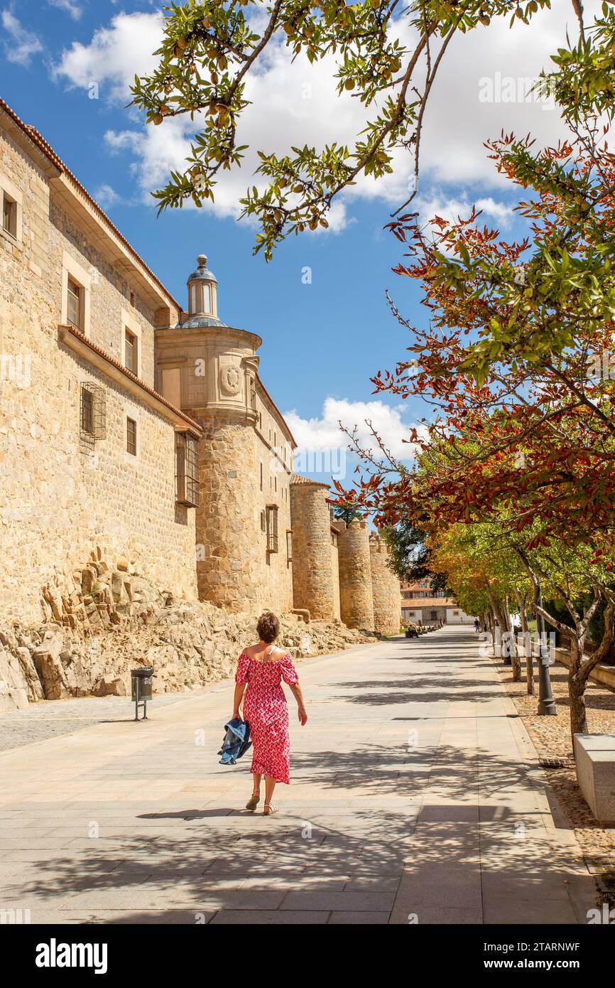 Woman walking by the ramparts of the fortified city walls in the