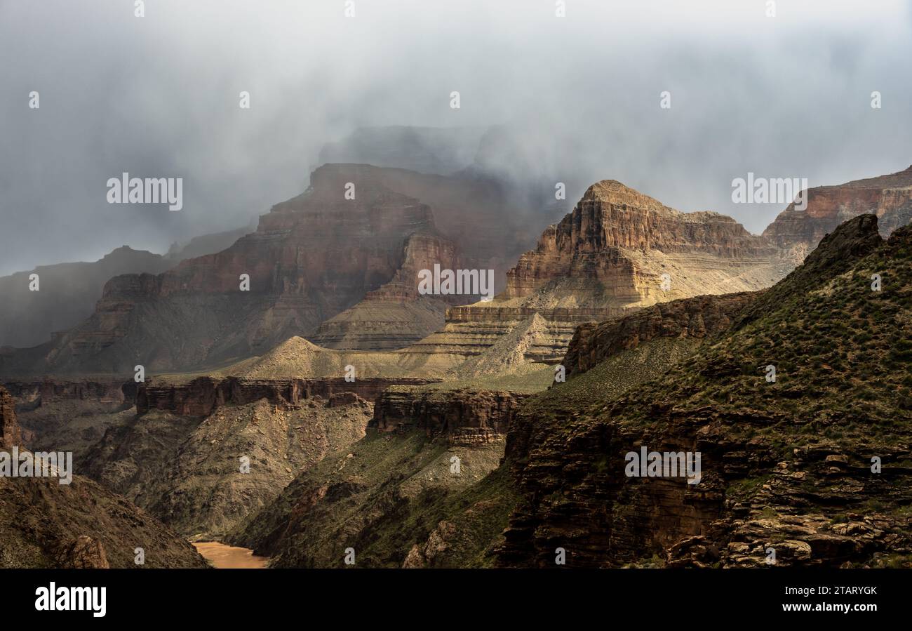 Clouds Hang Between The Layers of Rock Showing The Levels Of Grand Canyon National Park Stock Photo