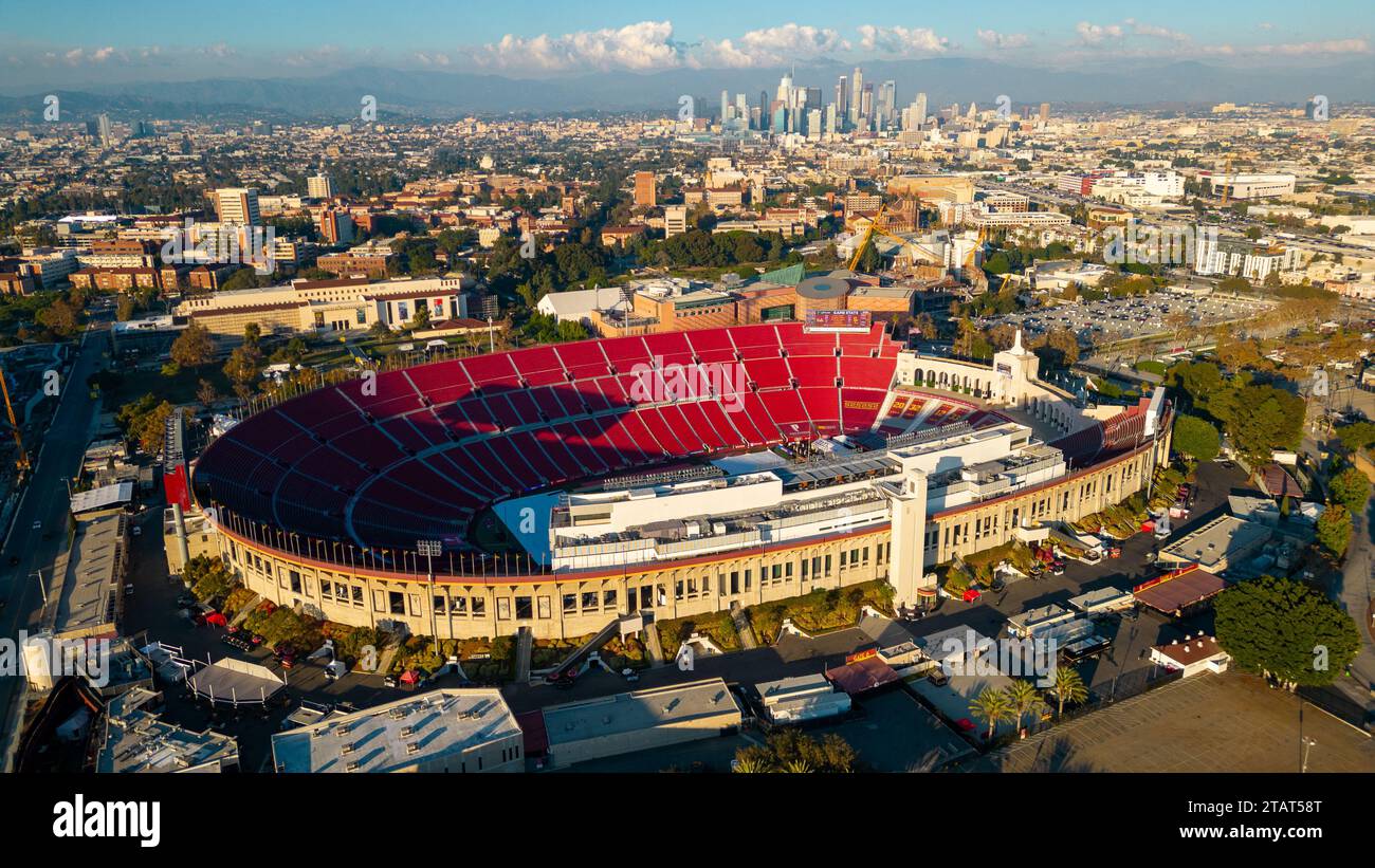 Los Angeles, CA - November 17, 2023: Los Angeles Memorial Coliseum, home to USC football, Olympics and other events, with Los Angeles skyline in the b Stock Photo