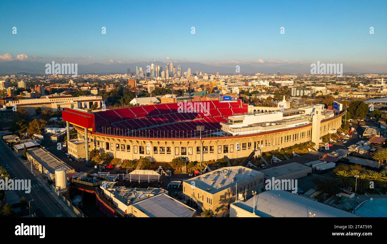 Los Angeles, CA - November 17, 2023: Los Angeles Memorial Coliseum, home to USC football, Olympics and other events, with Los Angeles skyline in the b Stock Photo