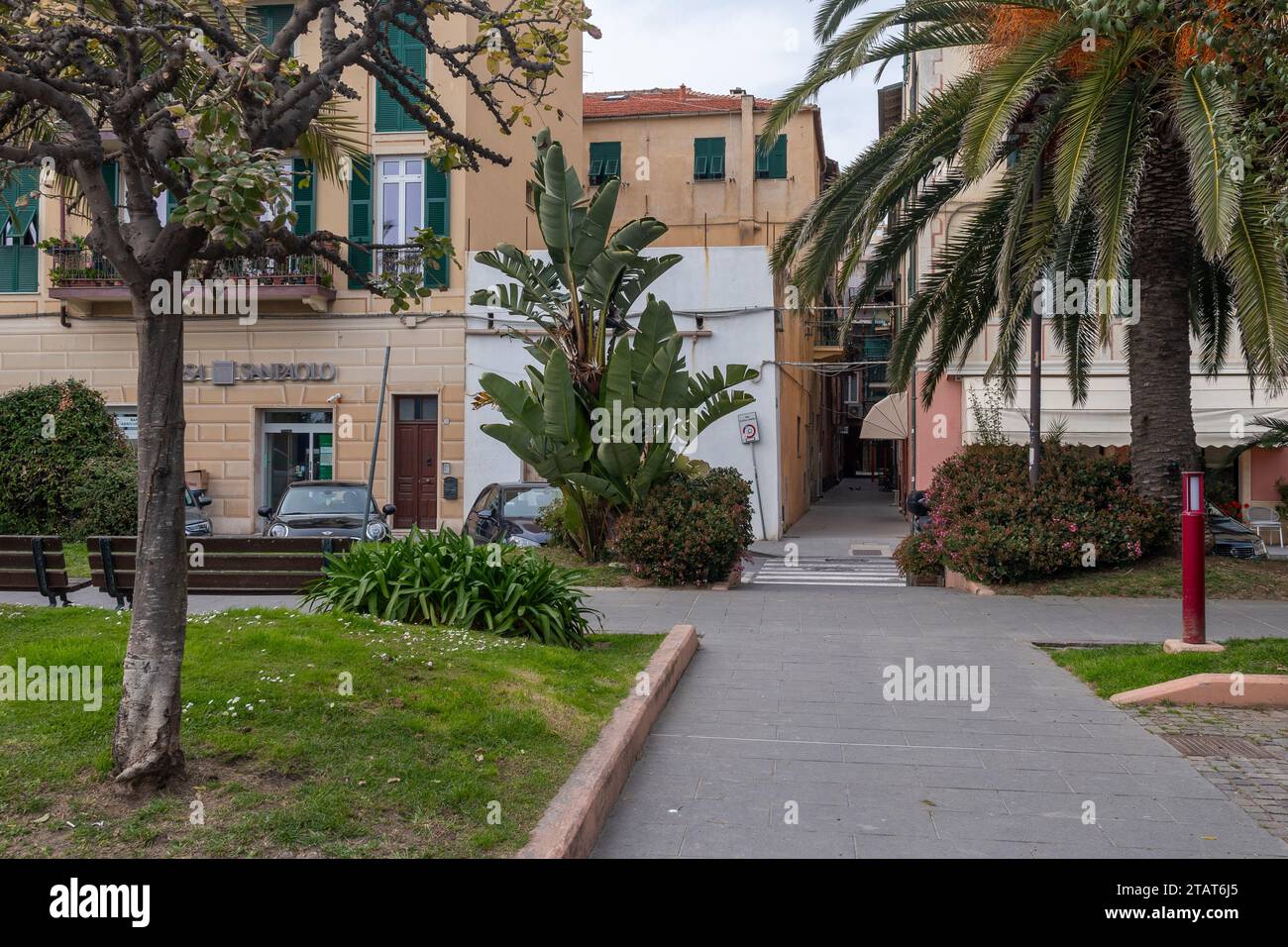 The promenade with palm trees, Via Concezione street and Vico Gandolino alley leading in the historic centre, Finale Ligure, Savona, Liguria, Italy Stock Photo