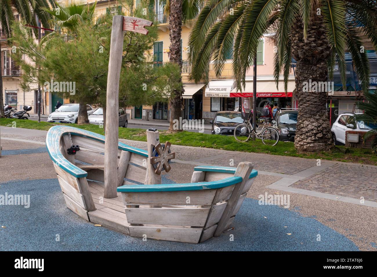 Wooden toy boat in a children's playground on the promenade of the popular holiday destination on the Italian Riviera di Ponente, Finale Ligure, Sav Stock Photo