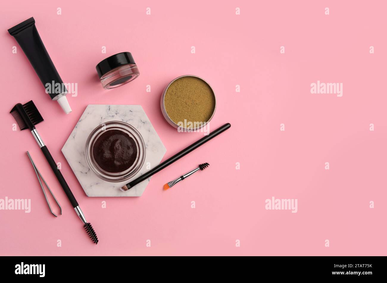 Flat lay composition with eyebrow henna and tools on pink background. Space for text Stock Photo