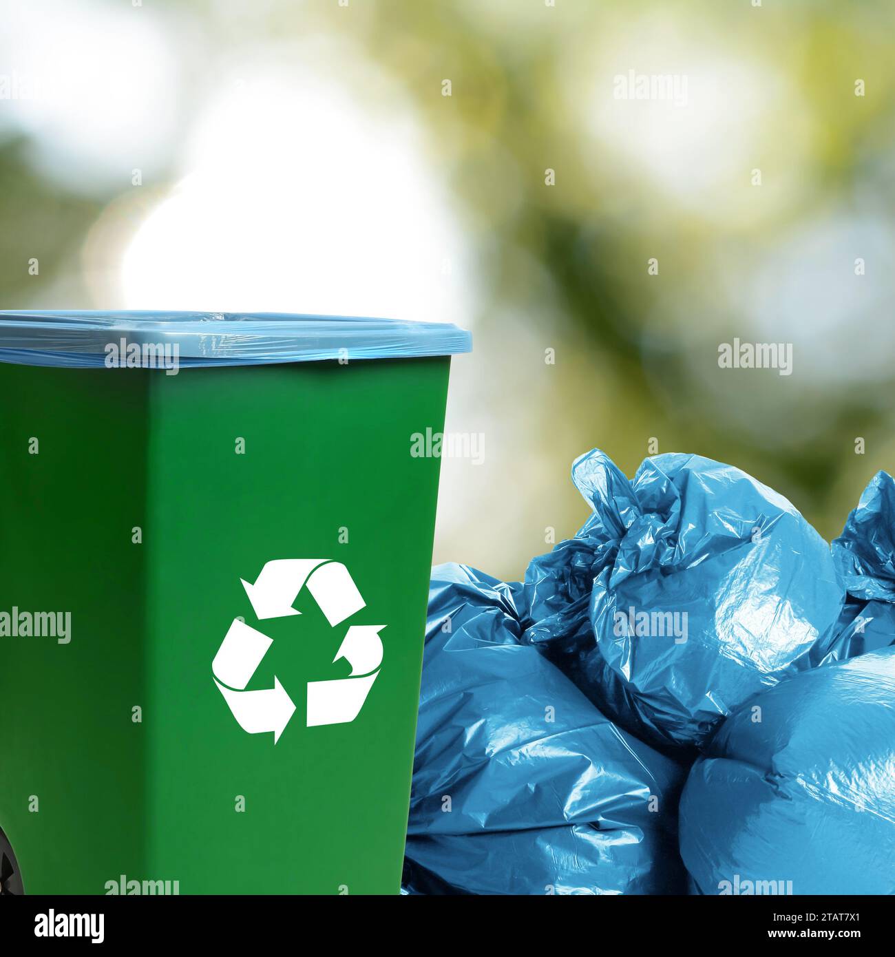 https://c8.alamy.com/comp/2TAT7X1/plastic-bags-full-of-garbage-and-waste-bin-on-blurred-background-space-for-text-2TAT7X1.jpg