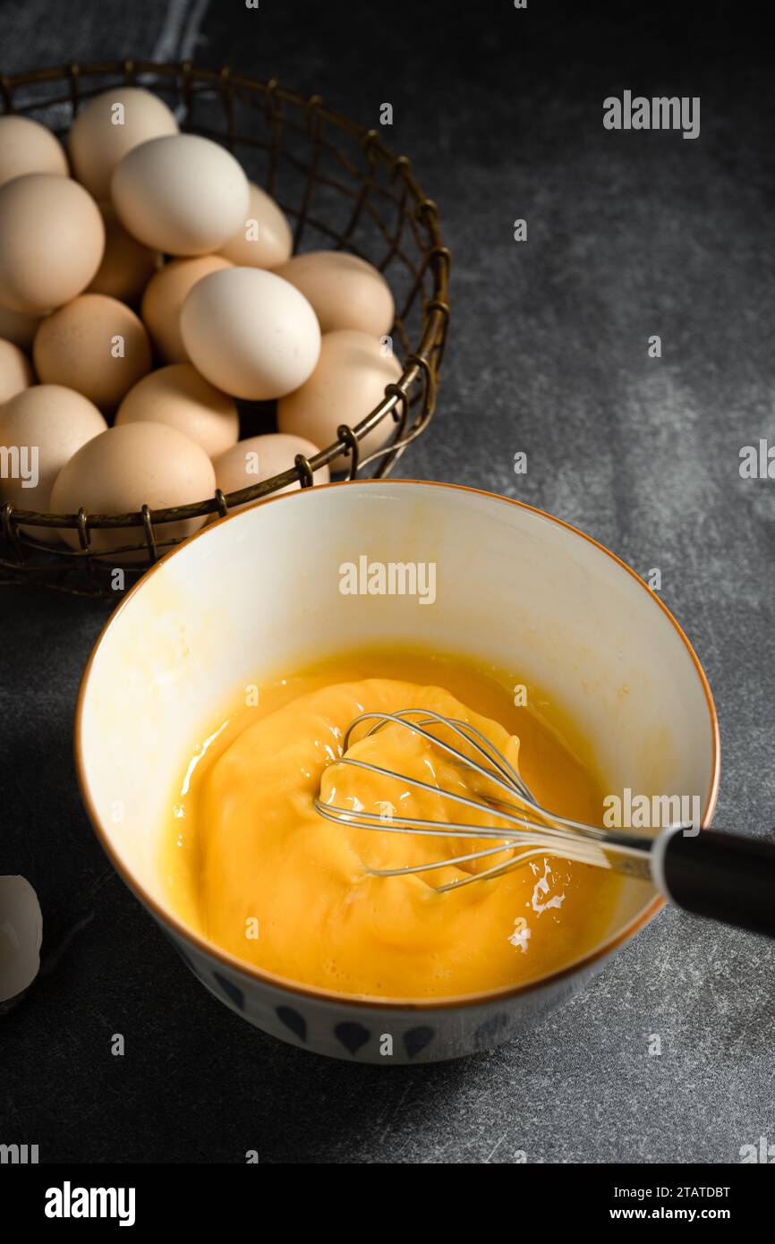 Whisk eggs in bowl Stock Photo