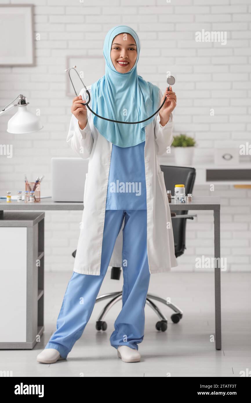 Female Muslim doctor in hijab with stethoscope at clinic. World Hijab
