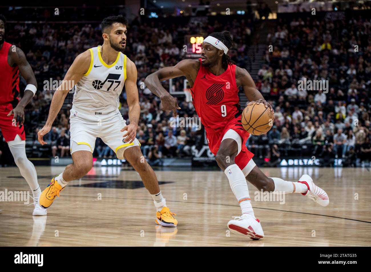 Portland Trail Blazers forward Jerami Grant (9) drives against Utah Jazz  center Omer Yurtseven (77) during the first half of an NBA basketball game  Saturday, Dec. 2, 2023, in Salt Lake City. (