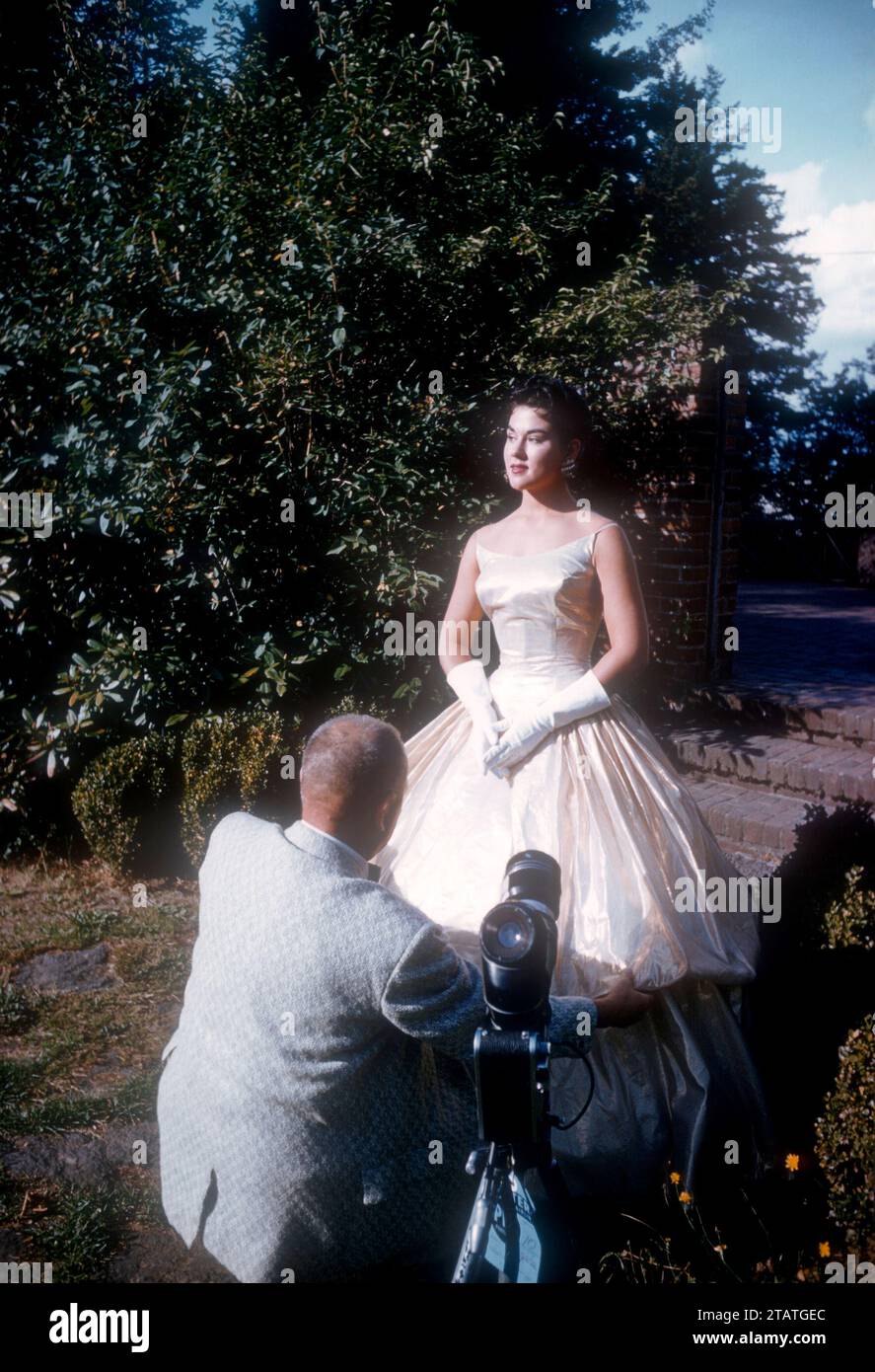 1951 A Woman Has Her Dress Fixed By The Cameraman Before Taking Photos 