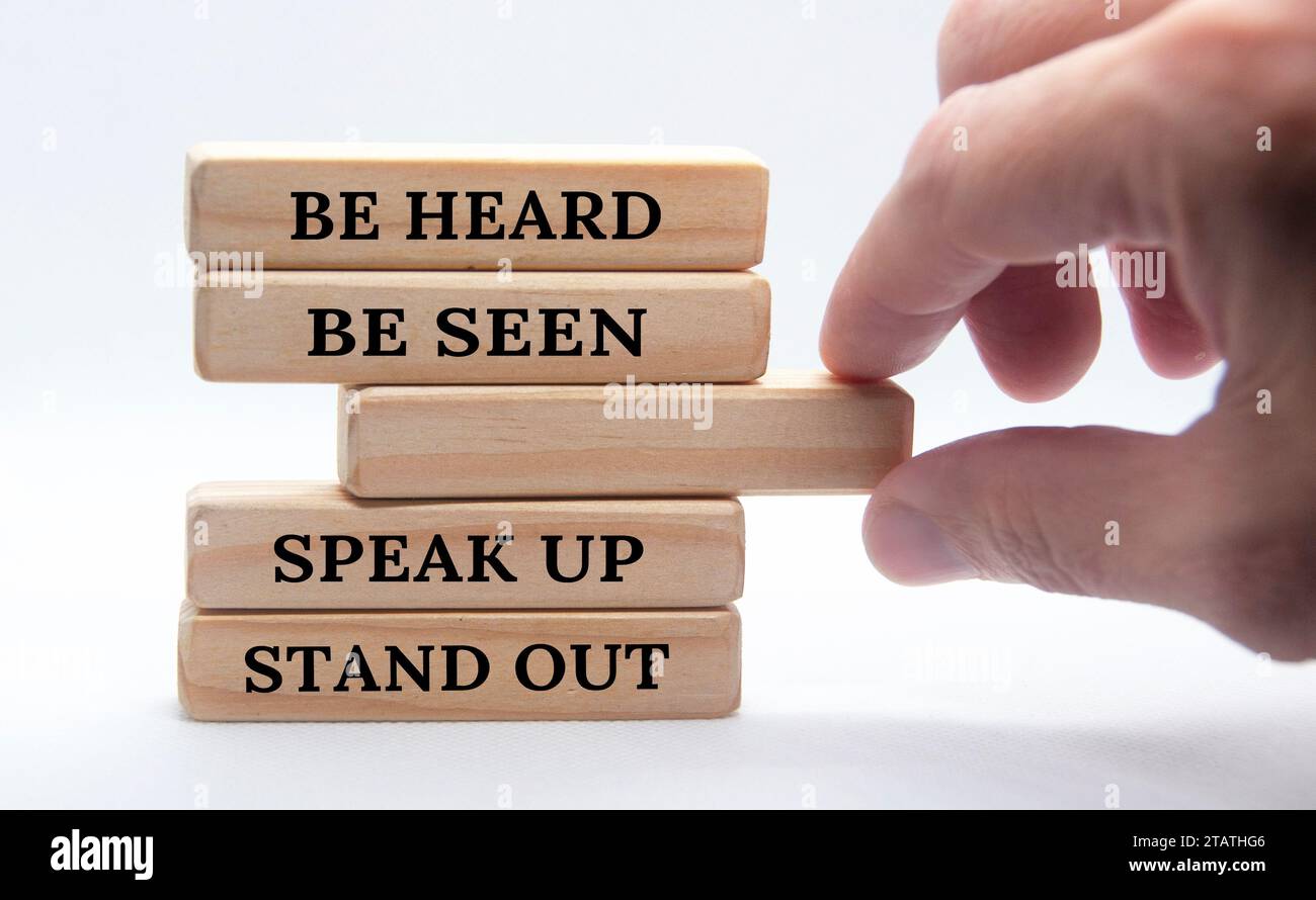 Be heard, be seen, speak up, stand out text on wooden block. Business