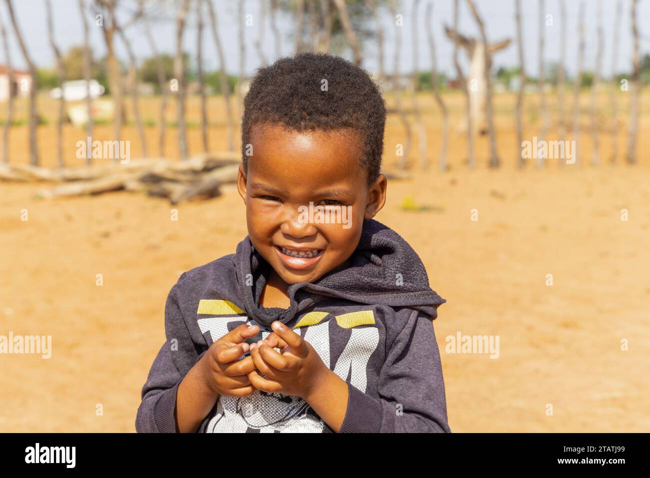 african village , boy with a hoodie playing in the yard Stock Photo