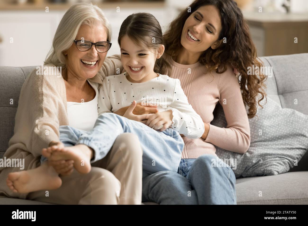 Happy joyful grandma and mom playing with cheerful kid Stock Photo - Alamy