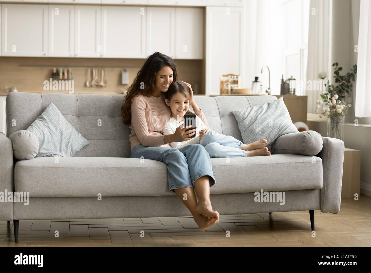 Happy mom and cute little tween kid girl using application Stock Photo ...
