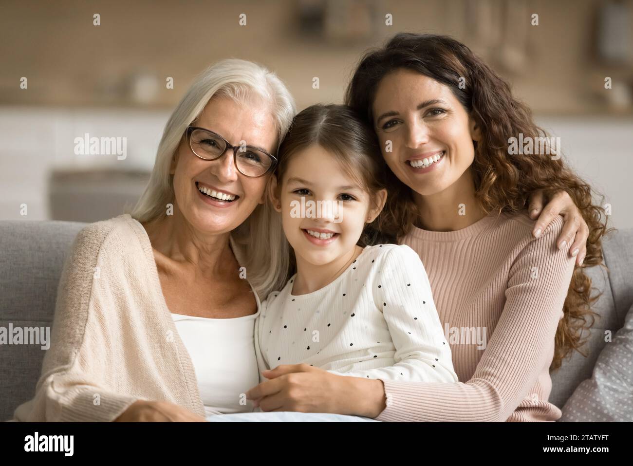 Happy mom and elderly grandma hugging cute tween girl Stock Photo - Alamy