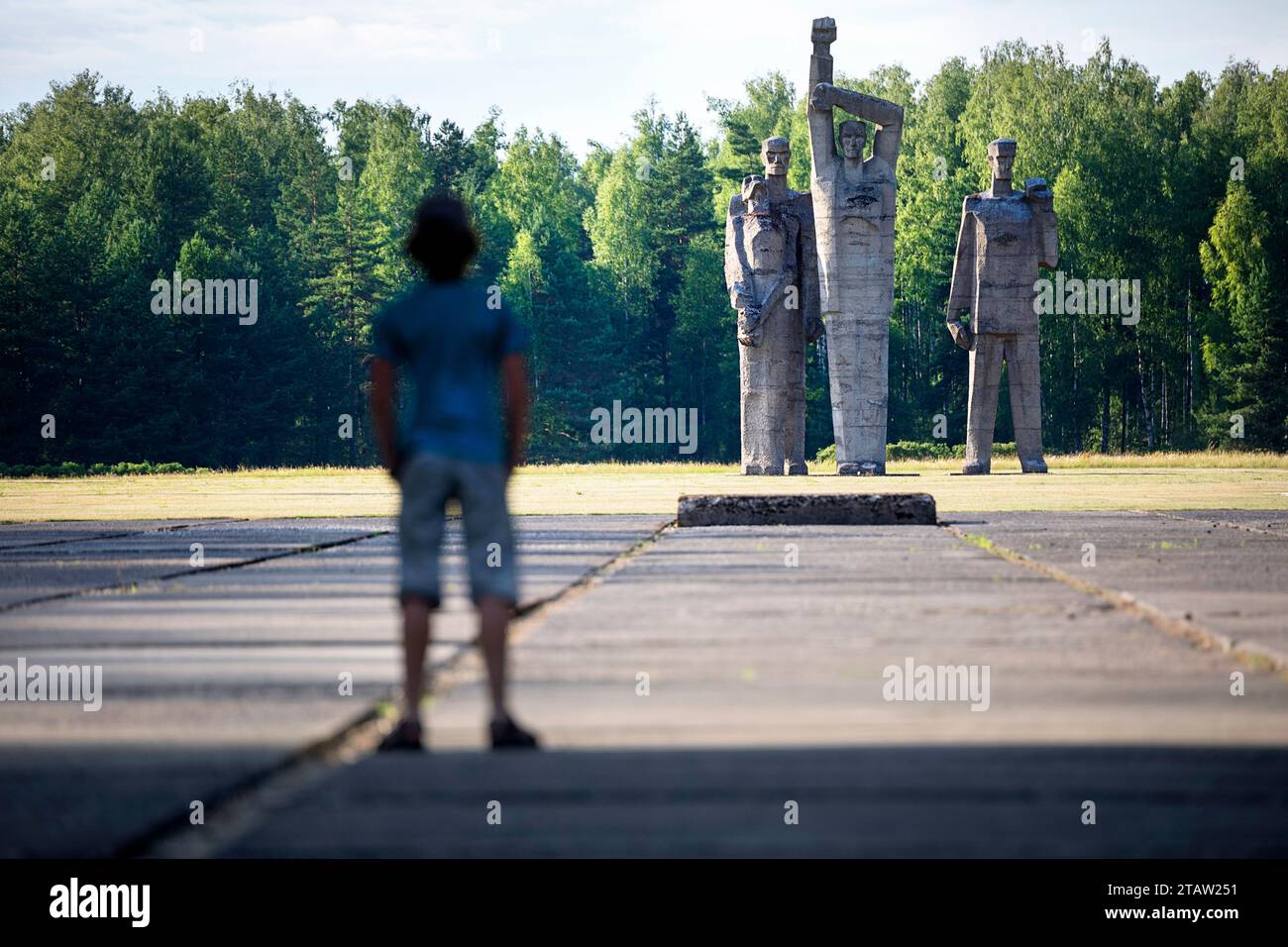 Tourist looking at the giant sculptures at Salaspils Memorial, one of Europe's largest monument complexes commemorating victims of Nazism, Latvia Stock Photo