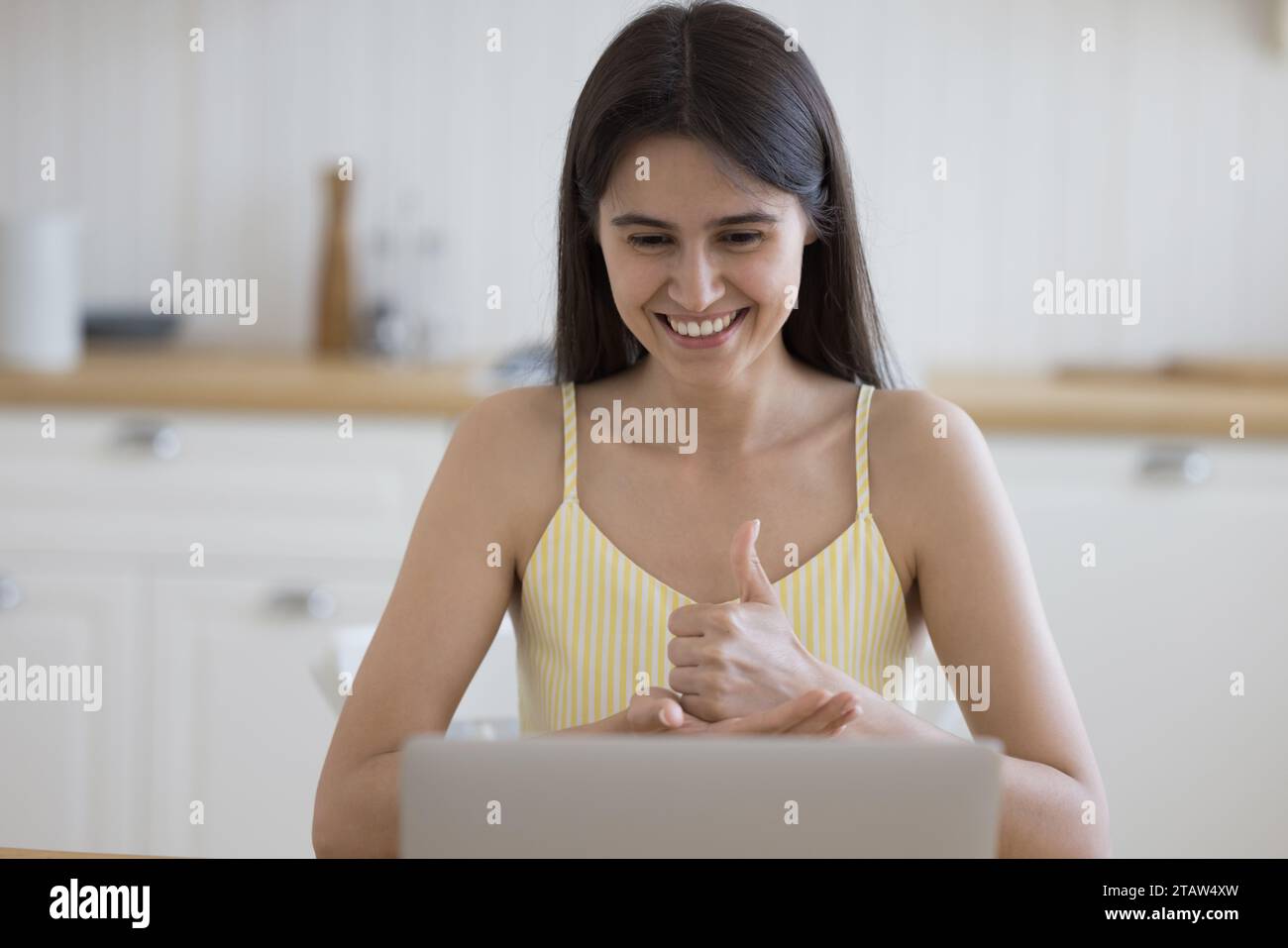 Woman with disability communicates to friend using hand gestures Stock Photo