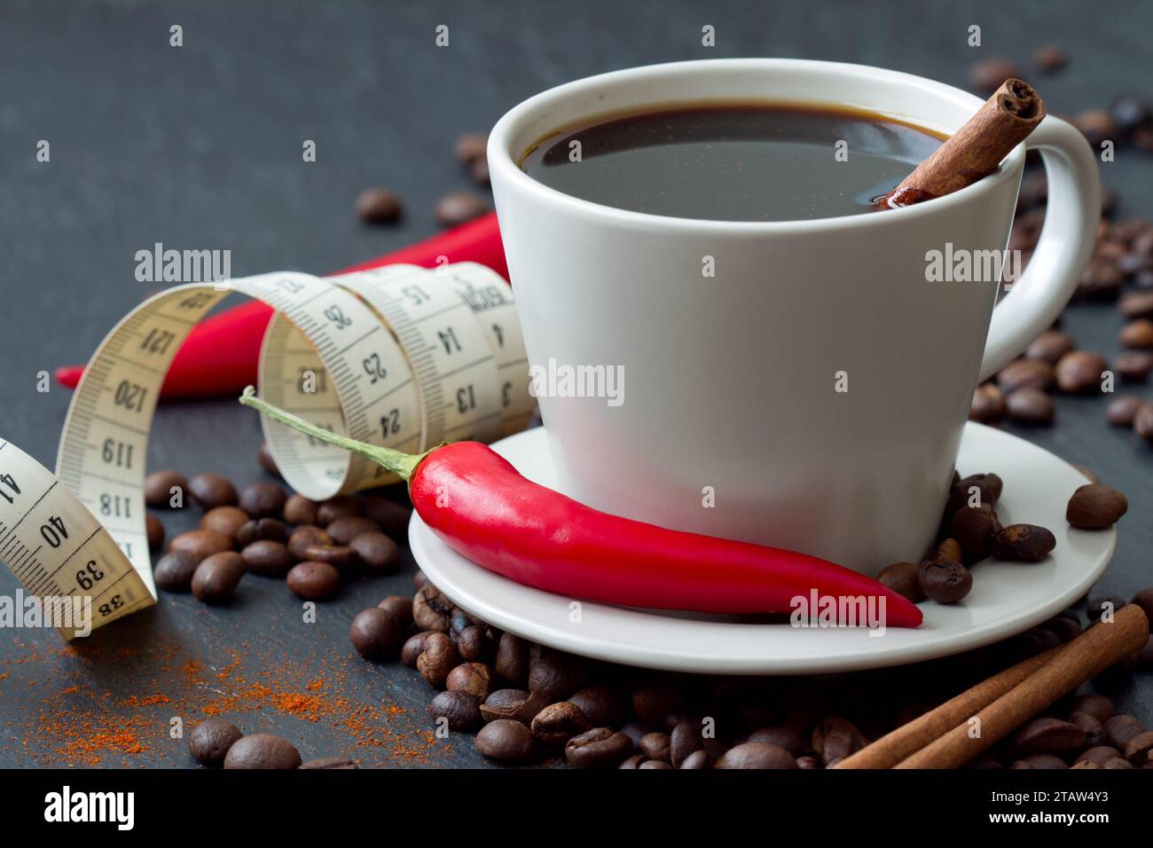 Spicy coffee with chili pepper and cinnamon with tape measure, natural