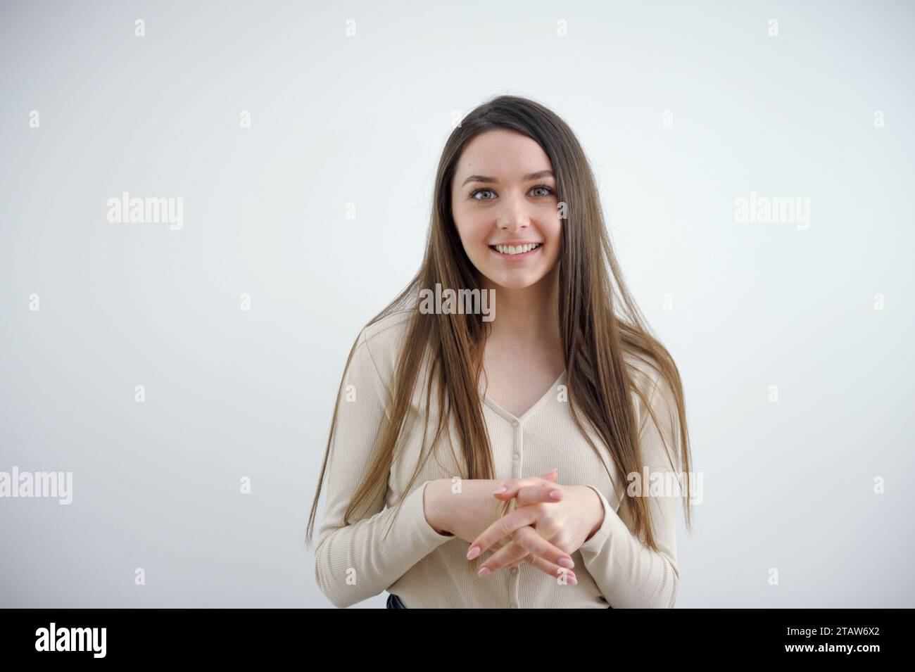 young-girl-crossed-her-fingers-on-her-chest-listens-attentively-smiles