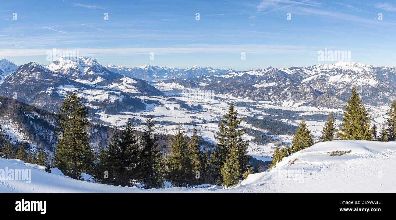 Panoramic view of a valley among the mountain peaks of the winter Alps, near the village of Kössen in Austria Stock Photo