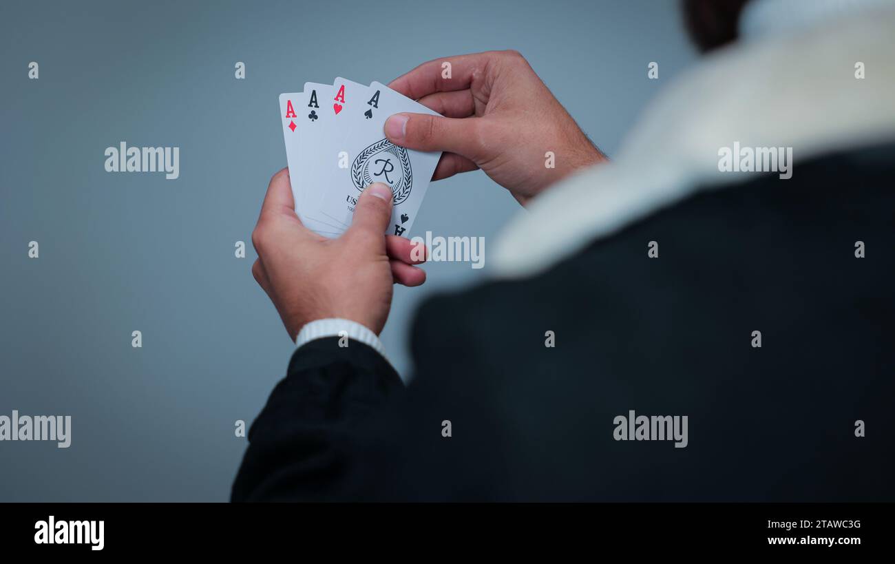 Young Man Holding Cards against gray background, Focus on Cards ...