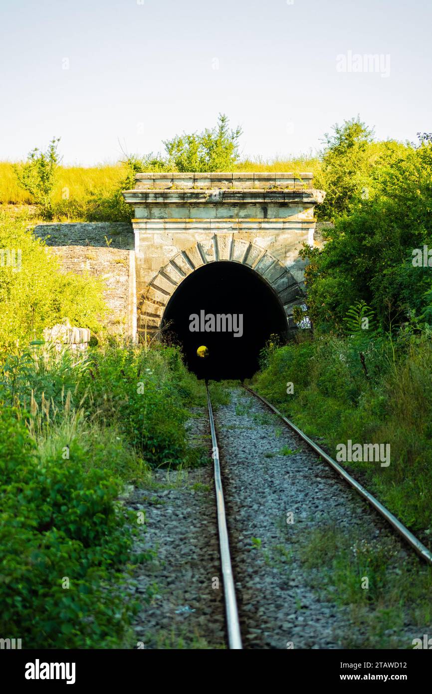 Beautiful entrance of a train tunnel, beautiful sun and nature, abandoned Stock Photo