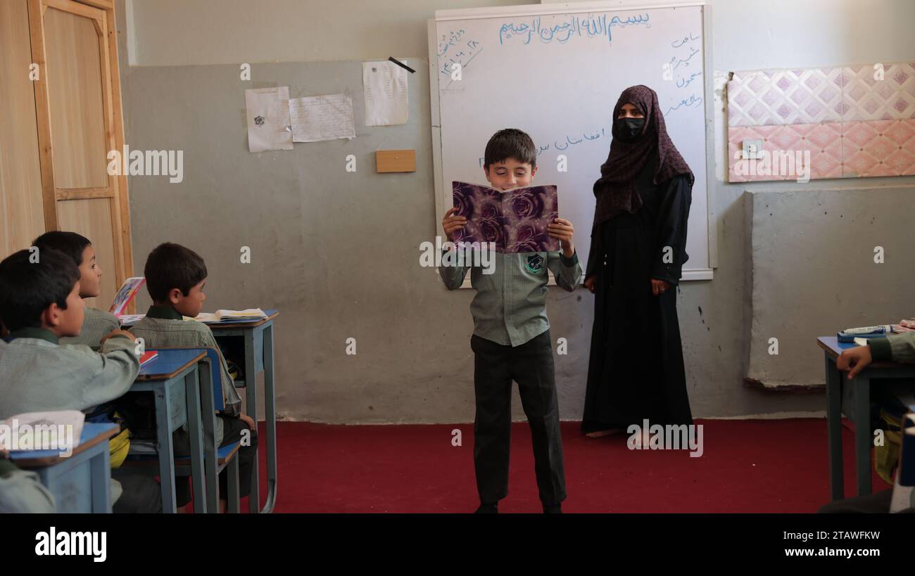 Education in Afghanistan: Schools in impoverished countries, schoolboys in a classroom in an Afghan school. Stock Photo