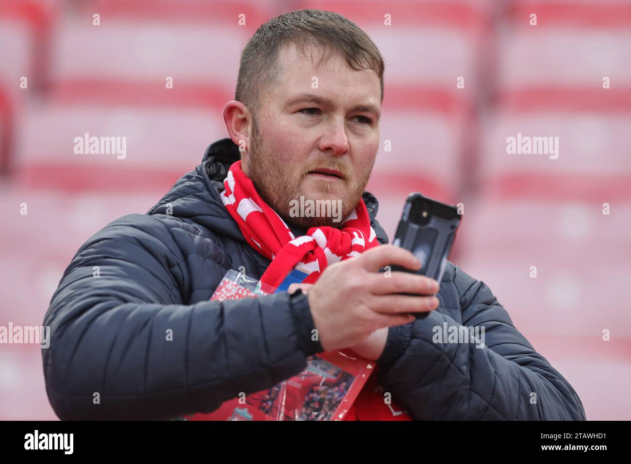 A Liverpool fan arrives ahead of the Premier League match Liverpool vs