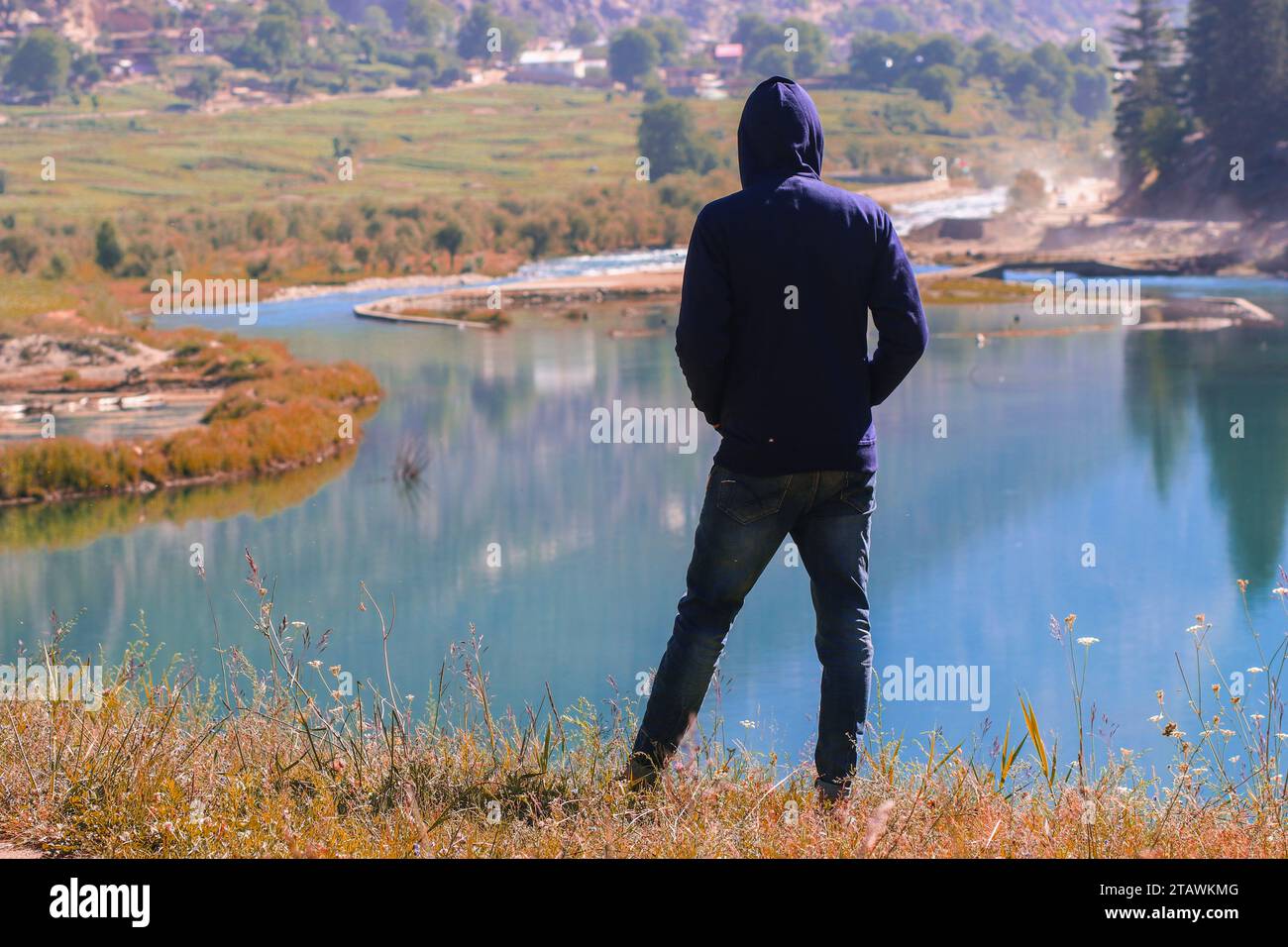 An unknown young man with a hoodie shot from the back. Stock Photo