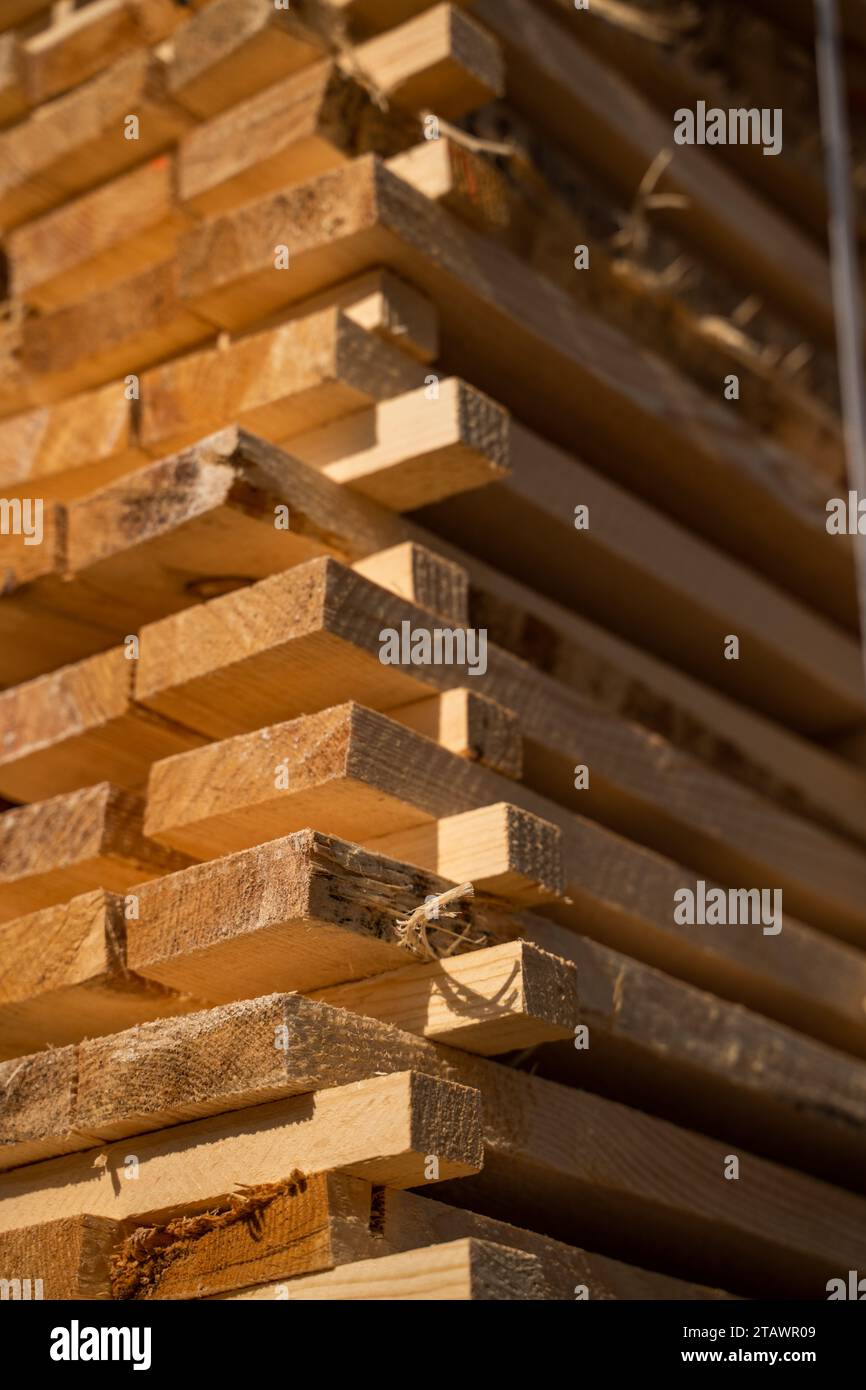 Stacked wooden planks in close-up at a outdoor lumber warehouse ...