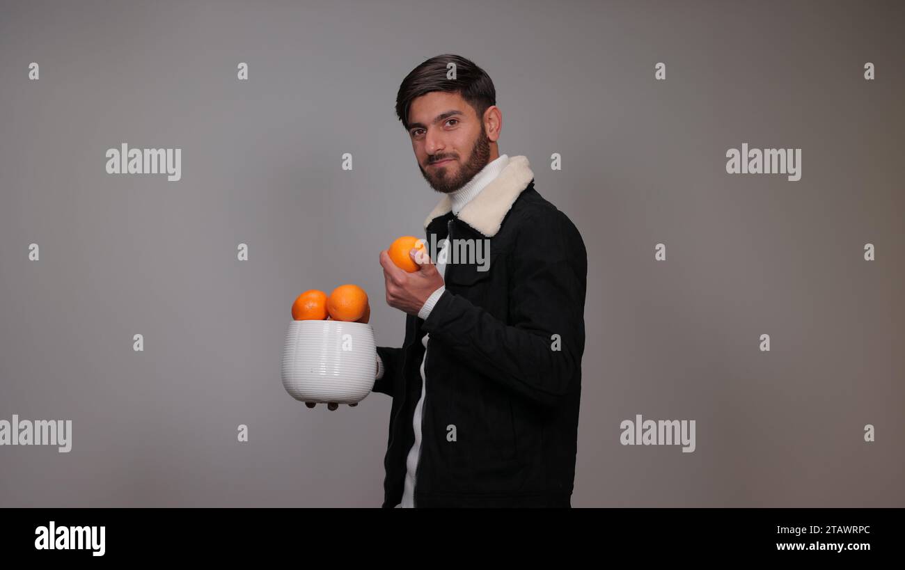 Man holding fresh orange fruit hi-res stock photography and images - Alamy
