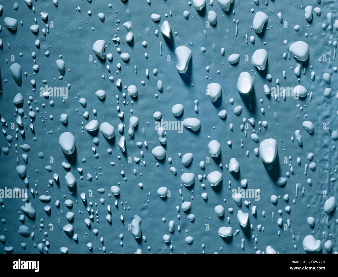 Water droplets against blue background Stock Photo