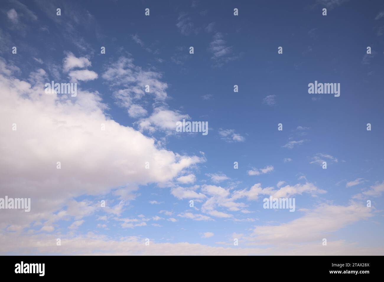 Blue sky with clouds | A sky with blue hues adorned by fluffy white clouds. Stock Photo