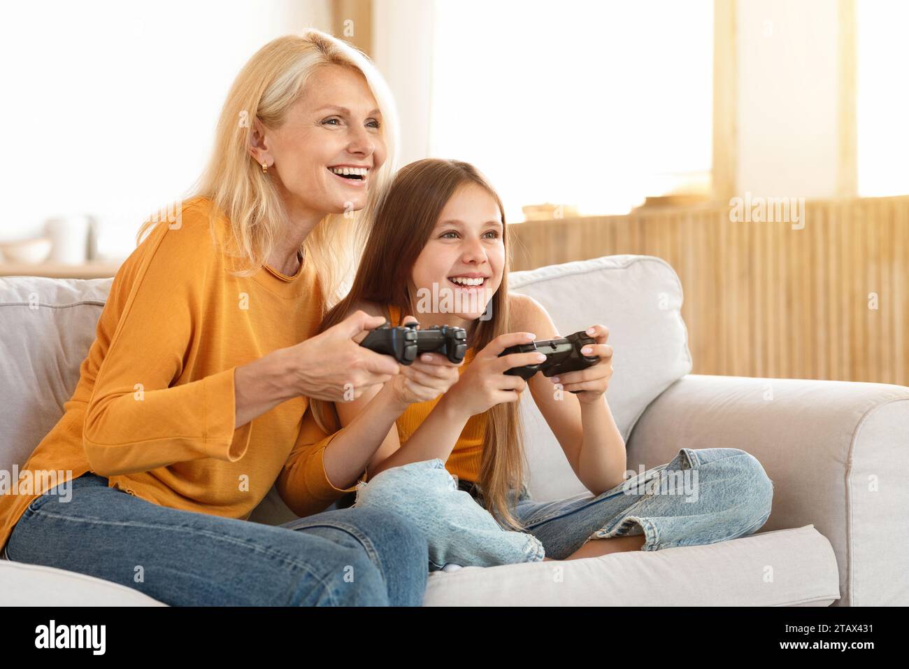 Happy teen girl having fun with her grandmother at home Stock Photo - Alamy