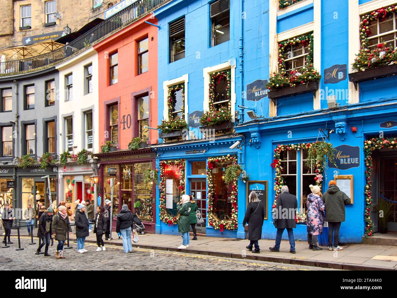 Edinburgh Scotland Victoria Street in early winter Christmas decorations on Maison Bleue and tourists in the street Stock Photo