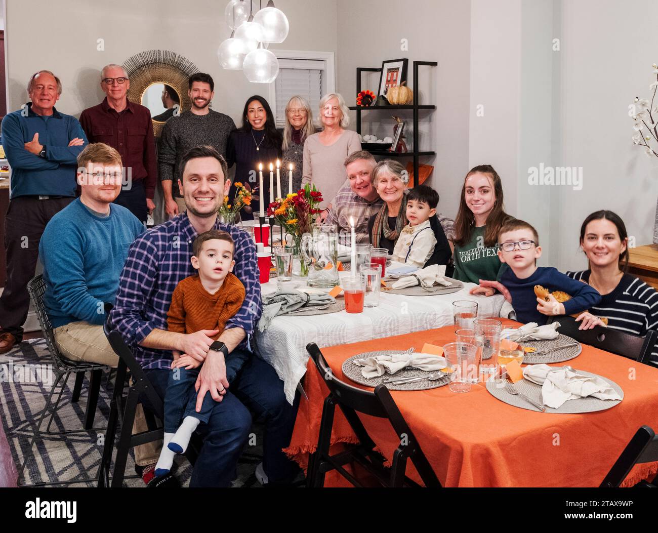 Interior group portrait of extended family gathered for Thanksgiving Day meal Stock Photo
