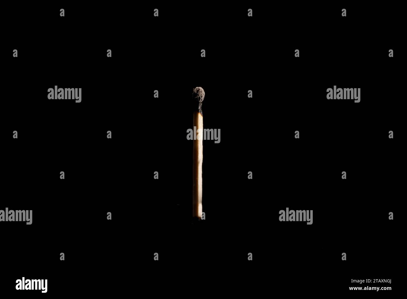 Lit and falling match on a black background. Stock Photo