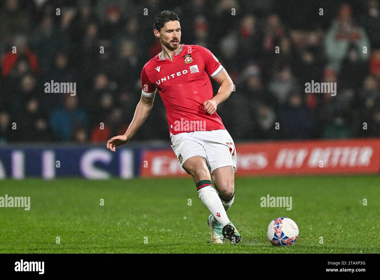 Evans 12 of Wrexham passes the ball during the Emirates FA Cup match Wrexham vs Yeovil