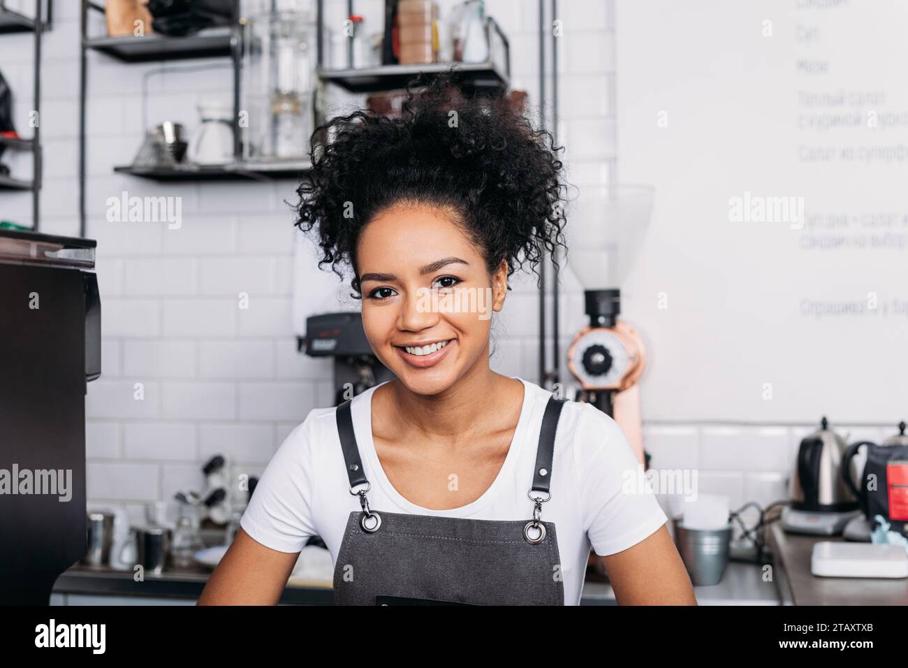 Cheerful waitress wearing apron hi-res stock photography and images - Alamy