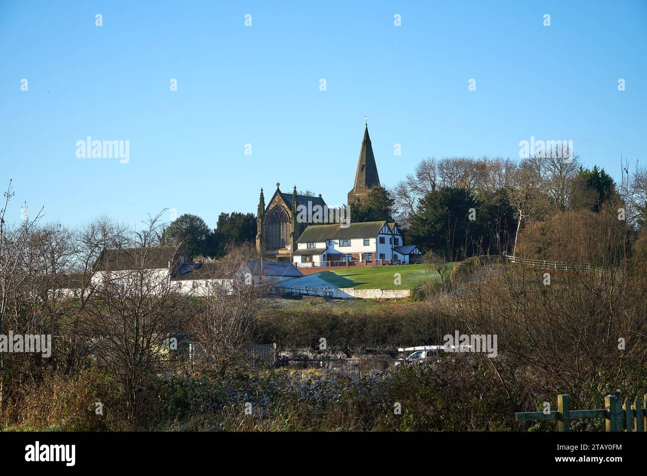 Church and farm house on a hillside in Sandiacre, Nottinghamshire, UK