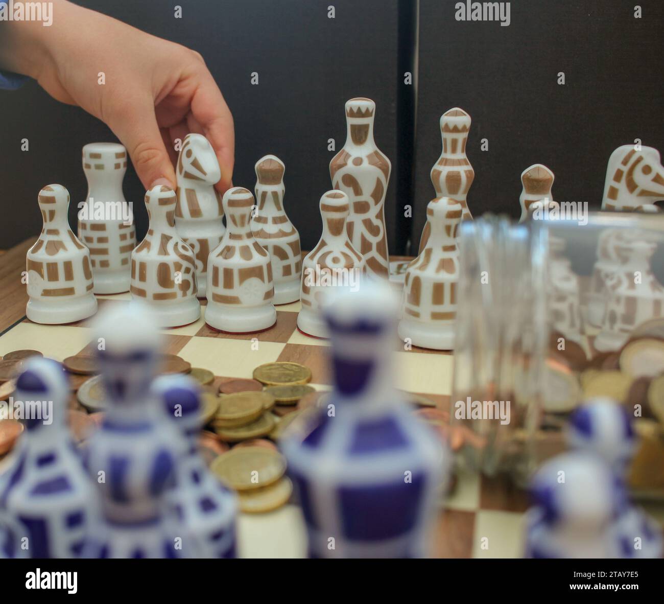 chess pieces and coins. Where is the best place to invest in times of crisis? Stock Photo