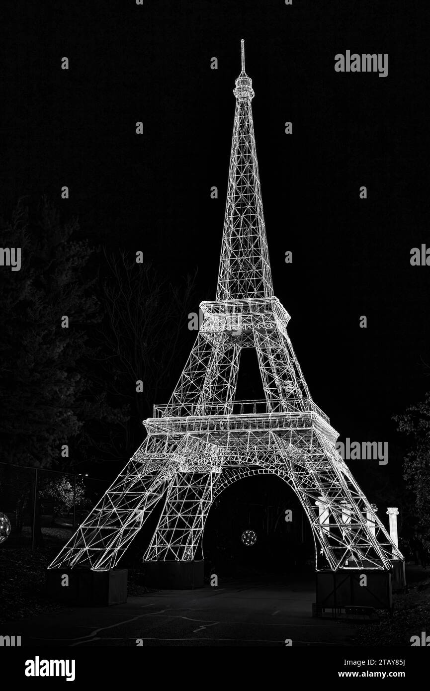 A black and white photograph of the iconic Eiffel Tower illuminated against the night sky Stock Photo