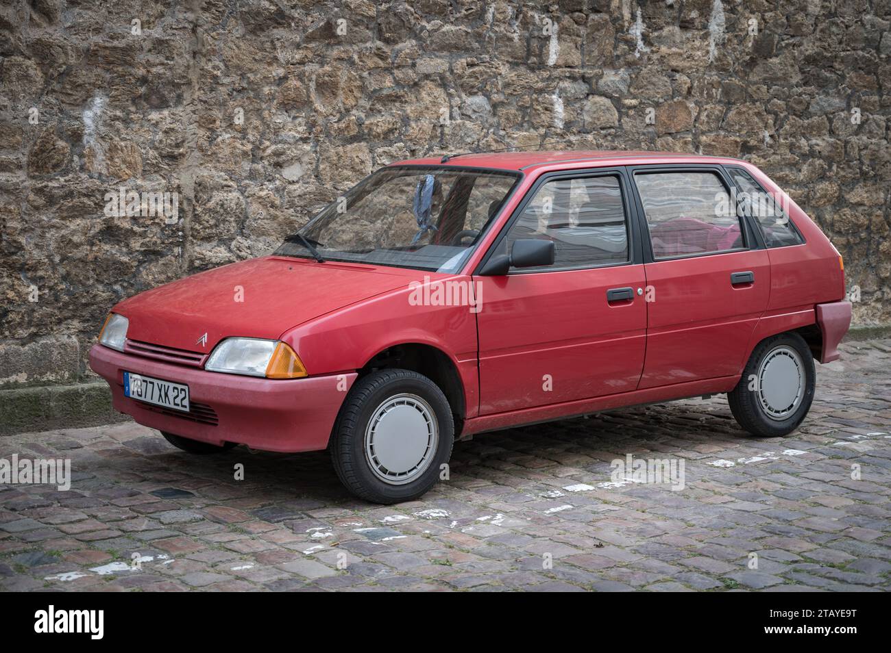 Classic French compact utility vehicle, it is a beautiful red Citroen AX 4 doors parked on the street Stock Photo