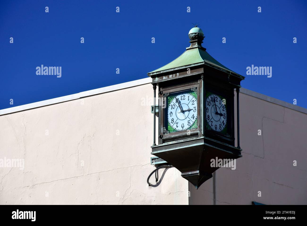 A vintage four sided clock on a building. Stock Photo